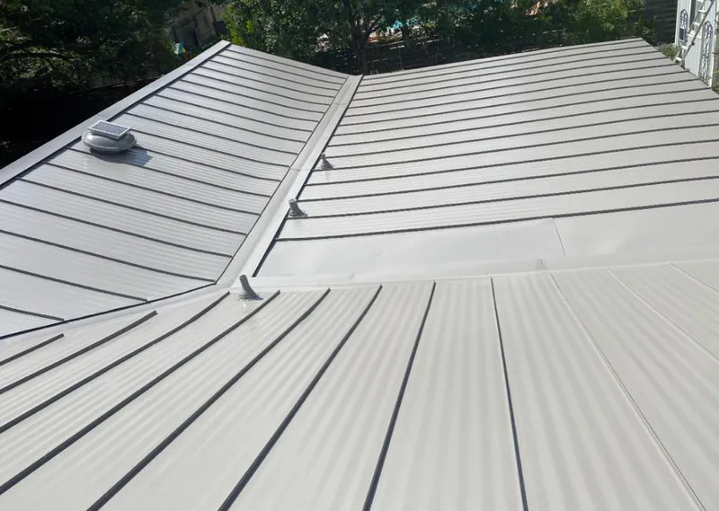 Solar attic fan installed on a metal roof for Roof Ventilation in Atascocita